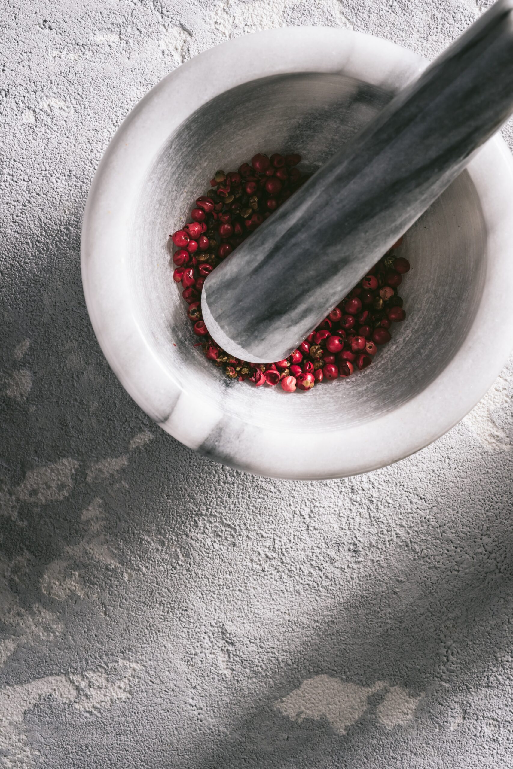 Pink Peppercorn in a Mortar with its Pestle