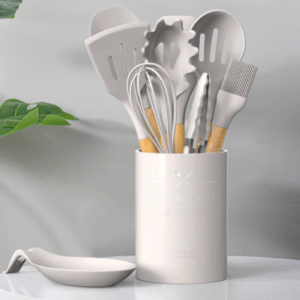 silicone kitchen utensils set in khaki color with wooden handles on a table