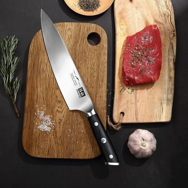 Japanese knife on a board with steak on the side