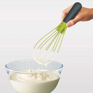 Silicon whisk used to whisk cream in a bowl