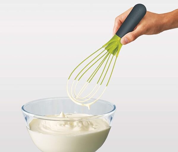 Silicon whisk used to whisk cream in a bowl